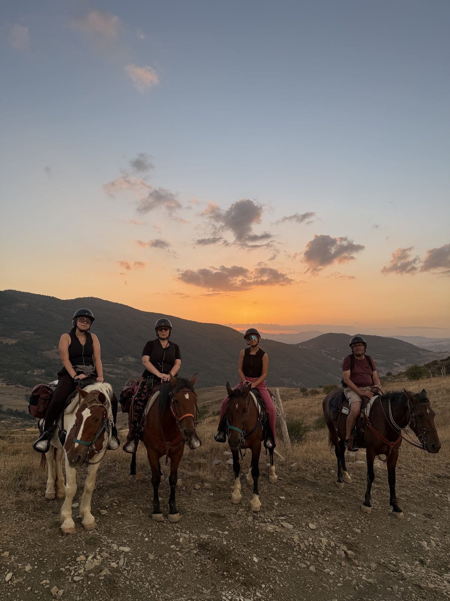 Gruppo di quattro cavalieri nella luce calda del tramonto tra le Dolomiti Lucane